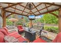 Outdoor gazebo featuring comfortable seating, a ceiling fan, and a mounted television at 11961 S Saunter Ln, Parker, CO 80138