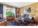 Bright living room featuring a comfy couch and large windows at 2872 S Zenobia St, Denver, CO 80236