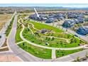 A picturesque community view showcases lush green spaces, walking paths, and well-maintained homes in a serene setting at 8056 Piney River Ave, Littleton, CO 80125