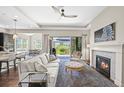 Inviting living room featuring a fireplace, ceiling fan, neutral tones, and sliding glass doors to the outdoor living space at 8056 Piney River Ave, Littleton, CO 80125