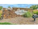 Stone entrance sign to Turnberry community with landscaping, and sunny sky at 13458 E 111Th Ave, Commerce City, CO 80022