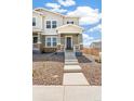 Charming townhome exterior with stone accents, inviting front porch, and well-maintained landscaping at 13458 E 111Th Ave, Commerce City, CO 80022