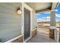 Inviting covered front porch with view of the open landscape at 13458 E 111Th Ave, Commerce City, CO 80022