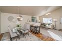 Bright dining room features hardwood floors and a built-in fireplace at 11228 W Progress Ave, Littleton, CO 80127