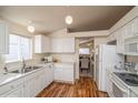 Clean kitchen with white cabinets and stainless steel appliances at 11228 W Progress Ave, Littleton, CO 80127