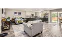 Open-concept living space featuring a modern kitchen with stainless steel appliances, flowing seamlessly into a cozy living area at 7465 S Ivy Way, Centennial, CO 80112