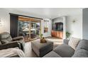 Comfortable living room features a sliding glass door to the patio and lots of seating space at 8348 W 90Th Ave, Broomfield, CO 80021