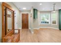 Bright and airy entryway with hardwood floors, coat rack and skylight, creating a welcoming ambiance into the home at 306 E Iowa Ave, Berthoud, CO 80513
