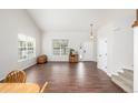 Bright living room features gleaming hardwood floors, large windows offering ample natural light, and neutral paint at 1335 Galactic Pl, Castle Rock, CO 80108