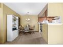 Inviting dining area adjacent to the kitchen, featuring a round table, chairs, and built-in shelving at 8335 Fairmount Dr # 4-102, Denver, CO 80247