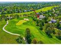 Scenic aerial view of the home with golf course views; highlighted with a red arrow at 7332 Woodglen Pl, Castle Pines, CO 80108