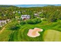 Beautiful home nestled within a lush landscape, adjoining an expansive golf course at 7332 Woodglen Pl, Castle Pines, CO 80108