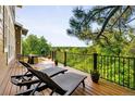 Outdoor deck featuring patio furniture, including lounge chairs, and a scenic wooded view at 7332 Woodglen Pl, Castle Pines, CO 80108
