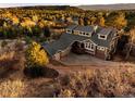 Aerial view of a well-maintained home featuring an attached garage and lush landscaping at 7332 Woodglen Pl, Castle Pines, CO 80108