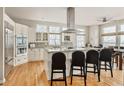 Spacious kitchen with stainless appliances, granite countertops, and large center island with seating at 7332 Woodglen Pl, Castle Pines, CO 80108