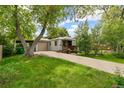 Charming single-story home with well-maintained lawn, driveway, garage and inviting front porch at 4285 Newland St, Wheat Ridge, CO 80033