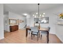 Modern dining room with stylish light fixture and seating for four at 1858 S Cole St, Lakewood, CO 80228