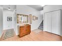 Entry hall featuring hardwood floors, staircase, and a decorative mirror at 1858 S Cole St, Lakewood, CO 80228
