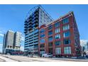 Full exterior view of modern condo building with brick and glass exterior at 2020 Arapahoe St # 1070, Denver, CO 80205