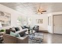 Inviting living room with plenty of natural light, hardwood floors, and comfortable furniture at 4445 Milwaukee St, Denver, CO 80216