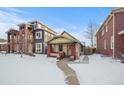 Brick bungalow home exterior, snowy front yard, walkway at 4234 N Raleigh St, Denver, CO 80212