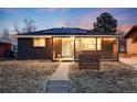 Inviting home exterior with solar panels, stylish facade, and a neatly landscaped front yard at 1742 S Alcott St, Denver, CO 80219
