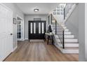 Bright entryway with hardwood floors, modern staircase, and ample natural light at 1563 E 131St Pl, Thornton, CO 80241