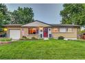 Spacious ranch home with a large yard and attached garage at 3701 W Greenwood Pl, Denver, CO 80236