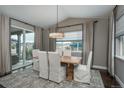 Elegant dining room with a large table and lots of natural light at 8010 Blue River Ave, Littleton, CO 80125