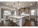 Bright kitchen with large island, pendant lighting, and stainless steel appliances at 8010 Blue River Ave, Littleton, CO 80125