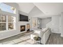 Bright living room with fireplace, soaring windows, and neutral decor at 12814 Jasmine St # C, Thornton, CO 80602