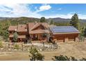 Beautiful house exterior boasting a blend of rustic charm and modern amenities, including solar panels at 33121 Lynx Ln, Evergreen, CO 80439