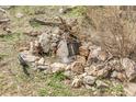 Rock waterfall featuring stones and water, adding a touch of nature and tranquility to the garden at 33121 Lynx Ln, Evergreen, CO 80439