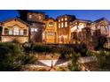 Beautiful stucco and stone home featuring manicured landscaping and a cozy front patio with a fire pit at 7767 Dante Dr, Littleton, CO 80125