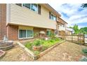 Charming backyard featuring a small brick wall, wooden barrel decorations, and a garden plot at 1209 S Terry St, Longmont, CO 80501