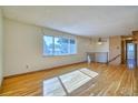 Sun-filled living area boasting hardwood floors and a large window overlooking the neighborhood at 1209 S Terry St, Longmont, CO 80501