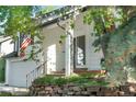 A delightful view of the home's front exterior showcasing a stone garden and inviting entryway at 6700 W 80Th Cir, Arvada, CO 80003