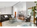 An inviting living room that connects to the dining area with hardwood floors and natural light at 6700 W 80Th Cir, Arvada, CO 80003