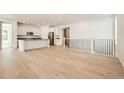 Spacious living room with hardwood floors and a modern staircase at 565 Twilight St, Erie, CO 80516