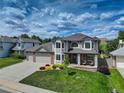 Beautiful two-story home with a well-kept lawn and charming front porch, complete with comfortable seating at 1825 Keota Ln, Superior, CO 80027