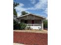 Charming bungalow with covered porch and red mulch landscaping at 4804 N Raleigh St, Denver, CO 80212