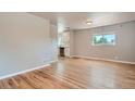 Open-concept living area featuring hardwood floors and views to a kitchen at 4804 N Raleigh St, Denver, CO 80212