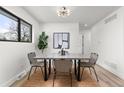 Chic dining room with modern lighting and minimalist decor. Window provides ample natural light at 11241 W 60Th Ave, Arvada, CO 80004