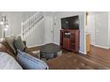 Cozy living room featuring a staircase, dark floors, and comfortable seating area at 3351 S Field St, Lakewood, CO 80227