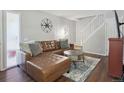 Living room with modern decor, dark floors, and ample seating at 3351 S Field St, Lakewood, CO 80227