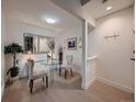 Stylish dining area with a glass table, modern chairs, decorative mirror, and ample natural light at 14495 E 1St Dr # C2, Aurora, CO 80011