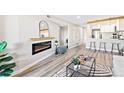 Open-concept living space with electric fireplace, seamlessly connecting to the modern kitchen at 4274 S Salida Way # 3, Aurora, CO 80013