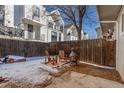 Cozy backyard featuring a fire pit, wooden chairs, and privacy fence for outdoor entertaining at 1244 S Reed St # 2, Lakewood, CO 80232
