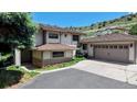 Charming home with a two-car garage, mature trees, and a well-maintained lawn at 7084 Fox Paw Trl, Littleton, CO 80125