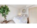 Cozy bedroom with a comfortable bed, accent art, and natural light at 8701 Huron St # 1-207, Thornton, CO 80260